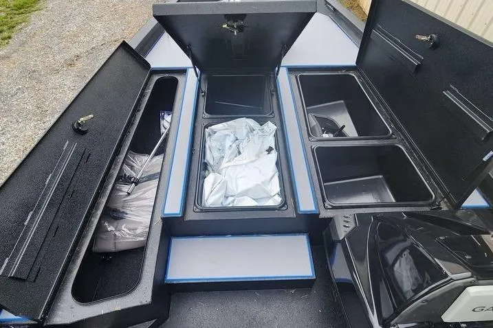 Slide: The Image of 2026 Xpress H20 Bass boat storage compartments open, showcasing ample space and organization. - 25