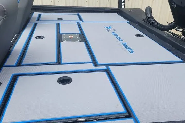 Slide: The Image of 2026 Xpress H20 Bass boat deck with storage compartments and logo. - 26