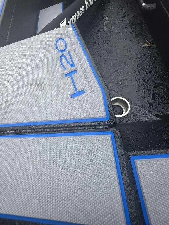 Slide: The Image of 2026 Xpress H20 Bass boat on trailer, parked on grass. - 4