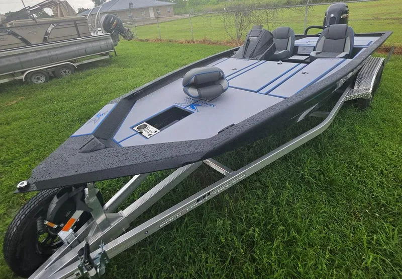 Slide: The Image of 2026 Xpress H20 Bass boat on trailer, parked on grass, with sleek design and modern features. - 7