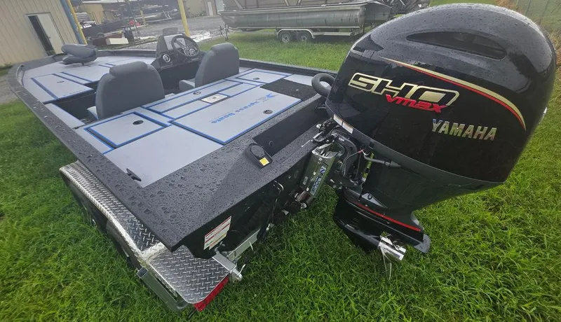 Slide: The Image of 2026 Xpress H20 Bass boat on trailer, side view. - 8