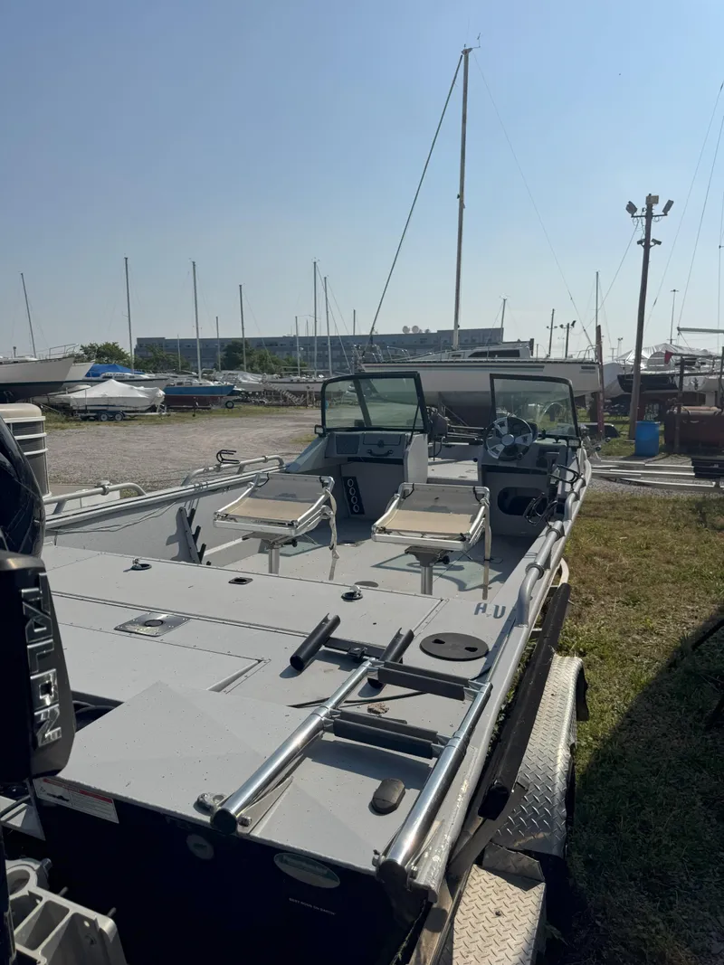 Slide: The Image of 2019 Sportsman 2400 G3 boat in a marina, featuring dual seats and steering console. - 10