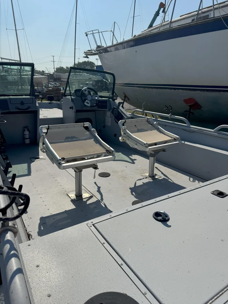 Slide: The Image of 2019 Sportsman 2400 G3 boat interior with two seats and steering wheel. - 6