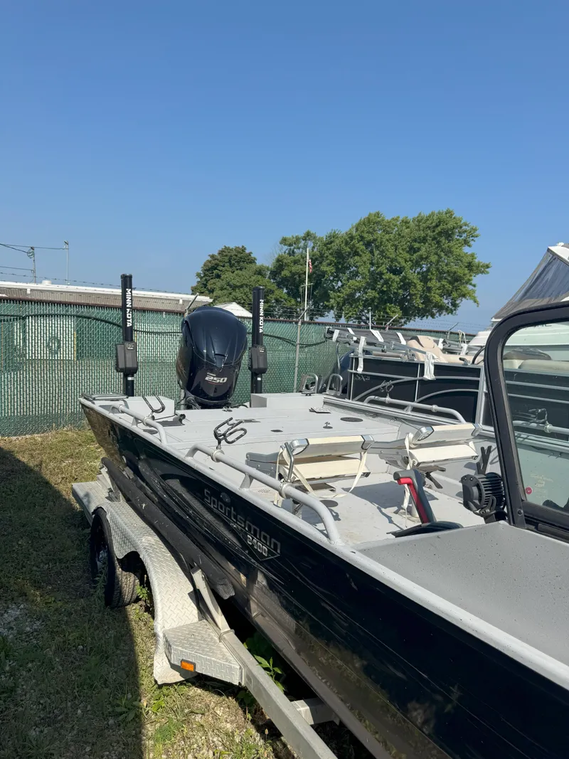 Slide: The Image of 2019 Sportsman 2400 G3 boat on trailer, parked outdoors under clear blue sky. - 8