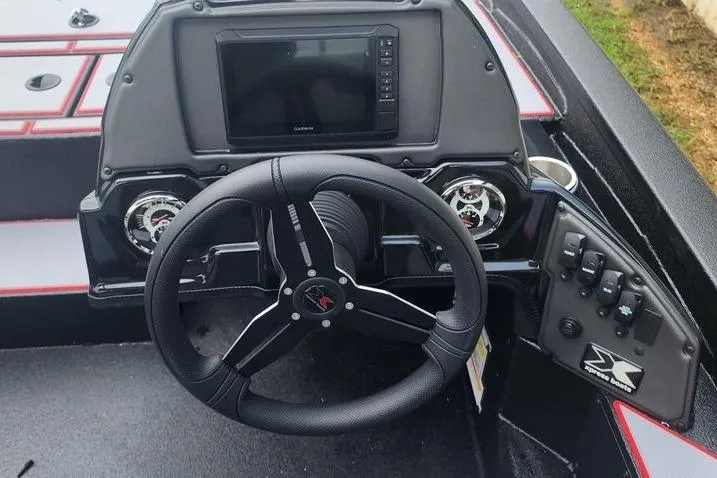 Slide: The Image of 2026 Xpress H20C Crappie Hyper-Lift Series boat dashboard with steering wheel and controls. - 17