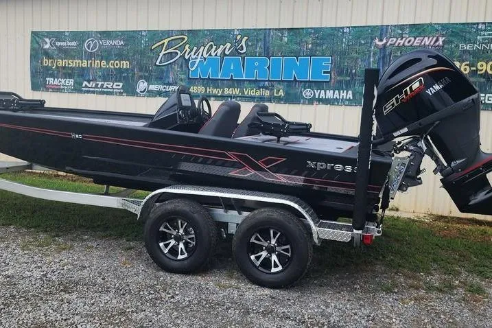 Slide: The Image of 2026 Xpress H20C Crappie Hyper-Lift Series boat on trailer at Bryan's Marine dealership. - 2