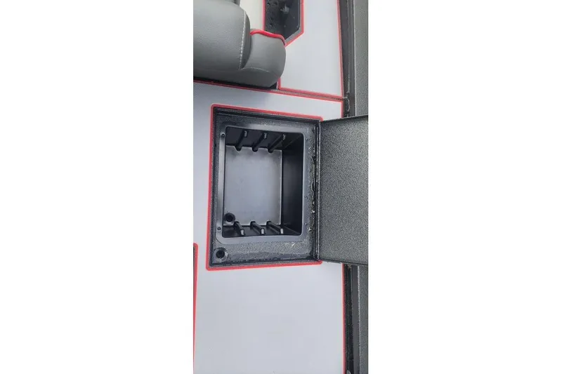 Slide: The Image of 2026 Xpress H20C Crappie Hyper-Lift Series boat storage compartment with red trim. - 21