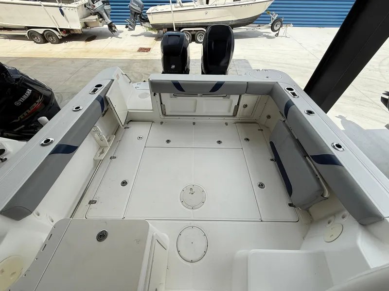 Slide: The Image of 2006 Boston Whaler 285 Conquest boat interior with seating and storage compartments. - 13