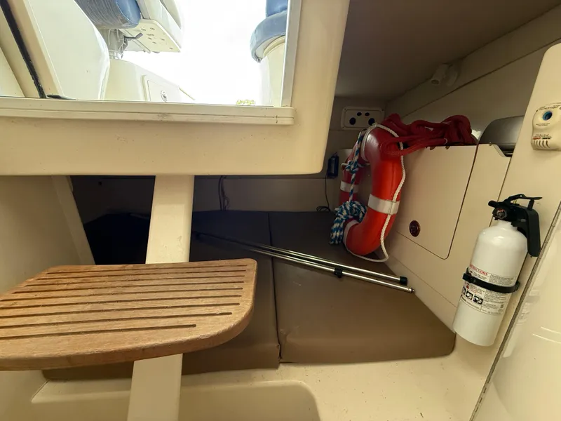 Slide: The Image of 2006 Boston Whaler 285 Conquest cabin interior with life preserver and fire extinguisher. - 16
