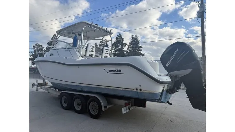 Slide: The Image of 2006 Boston Whaler 285 Conquest boat on trailer with Mercury outboard motor. - 6