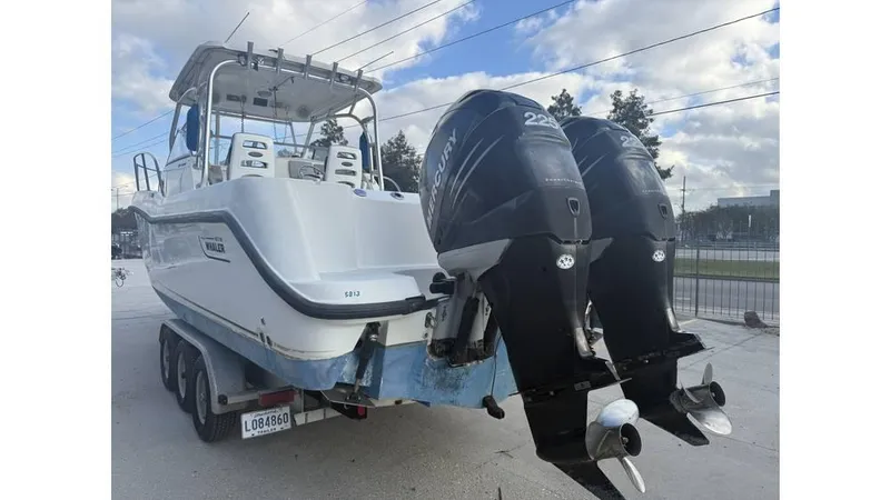 Slide: The Image of 2006 Boston Whaler 285 Conquest boat with dual Mercury outboard engines on a trailer. - 7