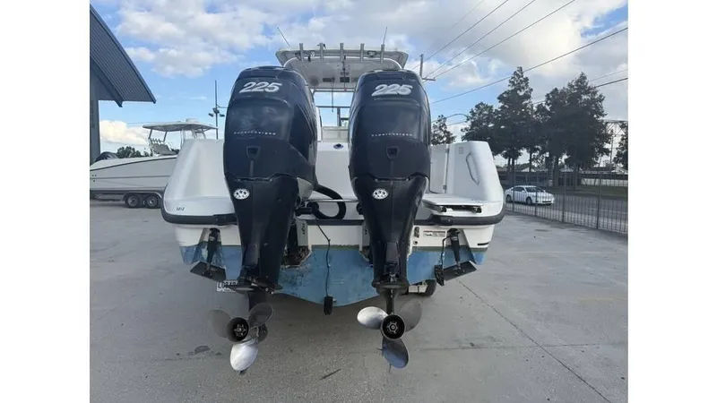 Slide: The Image of 2006 Boston Whaler 285 Conquest with twin 225 horsepower engines, parked outdoors. - 8