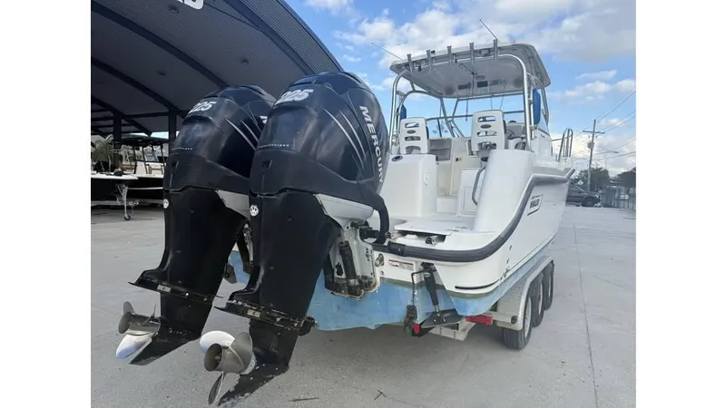 Slide: The Image of 2006 Boston Whaler 285 Conquest boat with dual Mercury outboard engines on a trailer. - 9