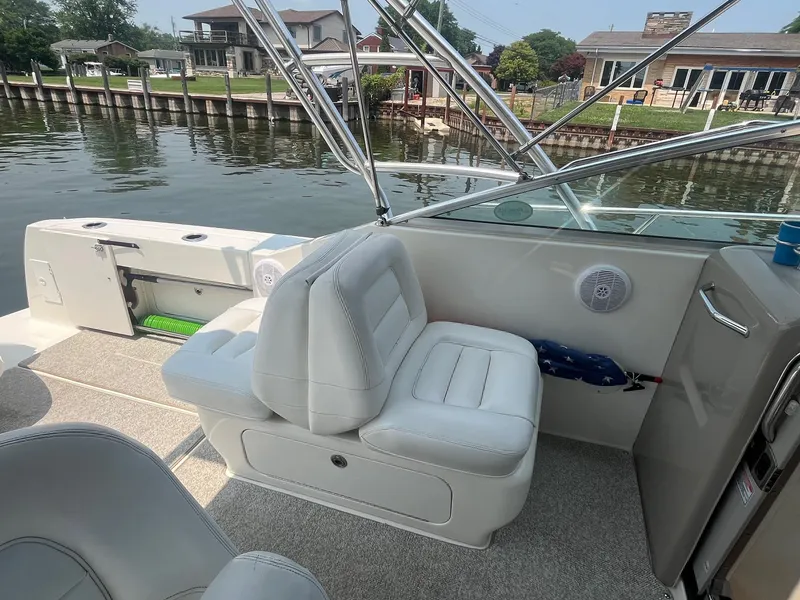Slide: The Image of 2007 Sea Ray 290 Amberjack boat interior with white seating and waterfront view. - 17