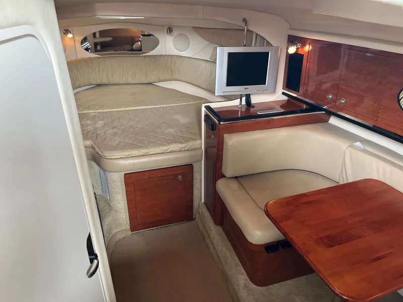 Slide: The Image of 2007 Sea Ray 290 Amberjack cabin interior with bed, seating, and TV. - 22