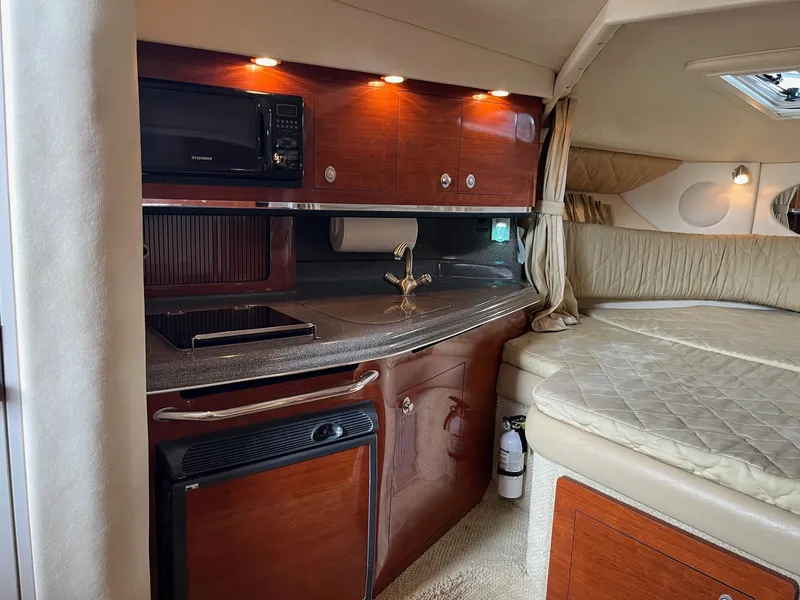 Slide: The Image of 2007 Sea Ray 290 Amberjack cabin interior with kitchenette and bed. - 23