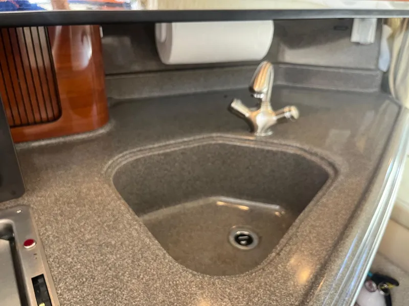 Slide: The Image of 2007 Sea Ray 290 Amberjack kitchen sink with modern faucet and countertop. - 27