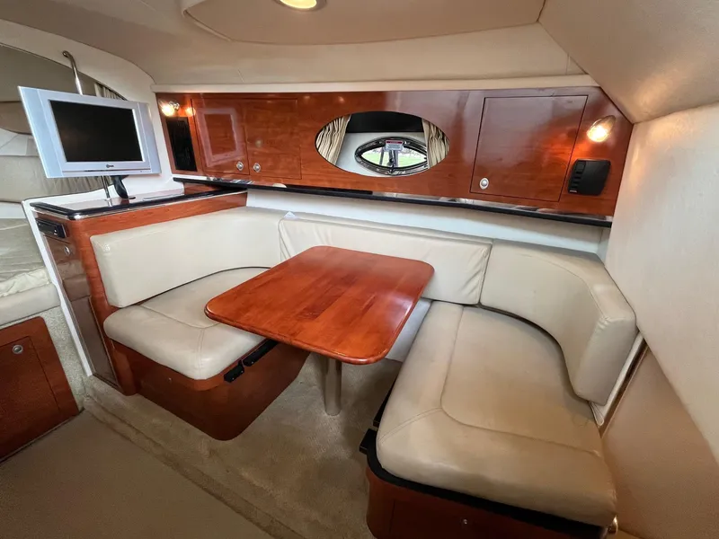 Slide: The Image of Luxurious interior of 2007 Sea Ray 290 Amberjack with cozy seating and wooden table. - 30