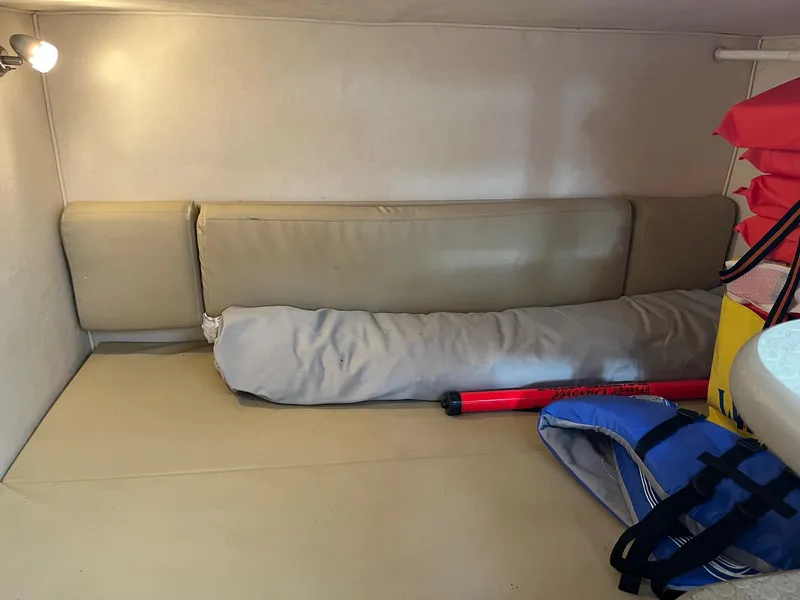 Slide: The Image of 2007 Sea Ray 290 Amberjack cabin interior with cushions, life jackets, and safety equipment. - 34
