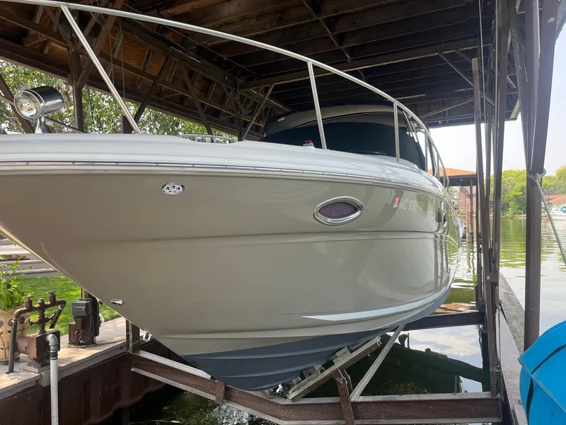 Slide: The Image of 2007 Sea Ray 290 Amberjack boat docked under a wooden shelter. - 5