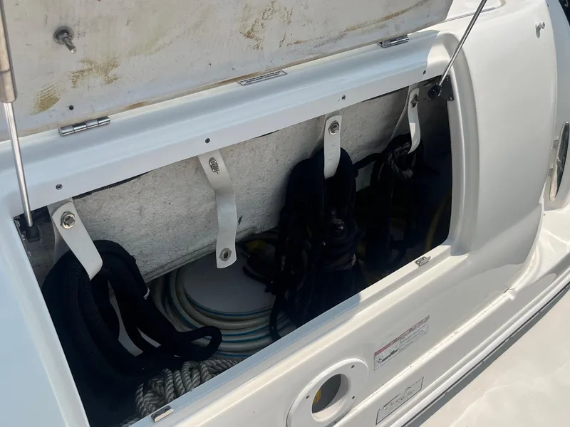 Slide: The Image of Storage compartment on a 2007 Sea Ray 290 Amberjack boat, containing ropes and equipment. - 9