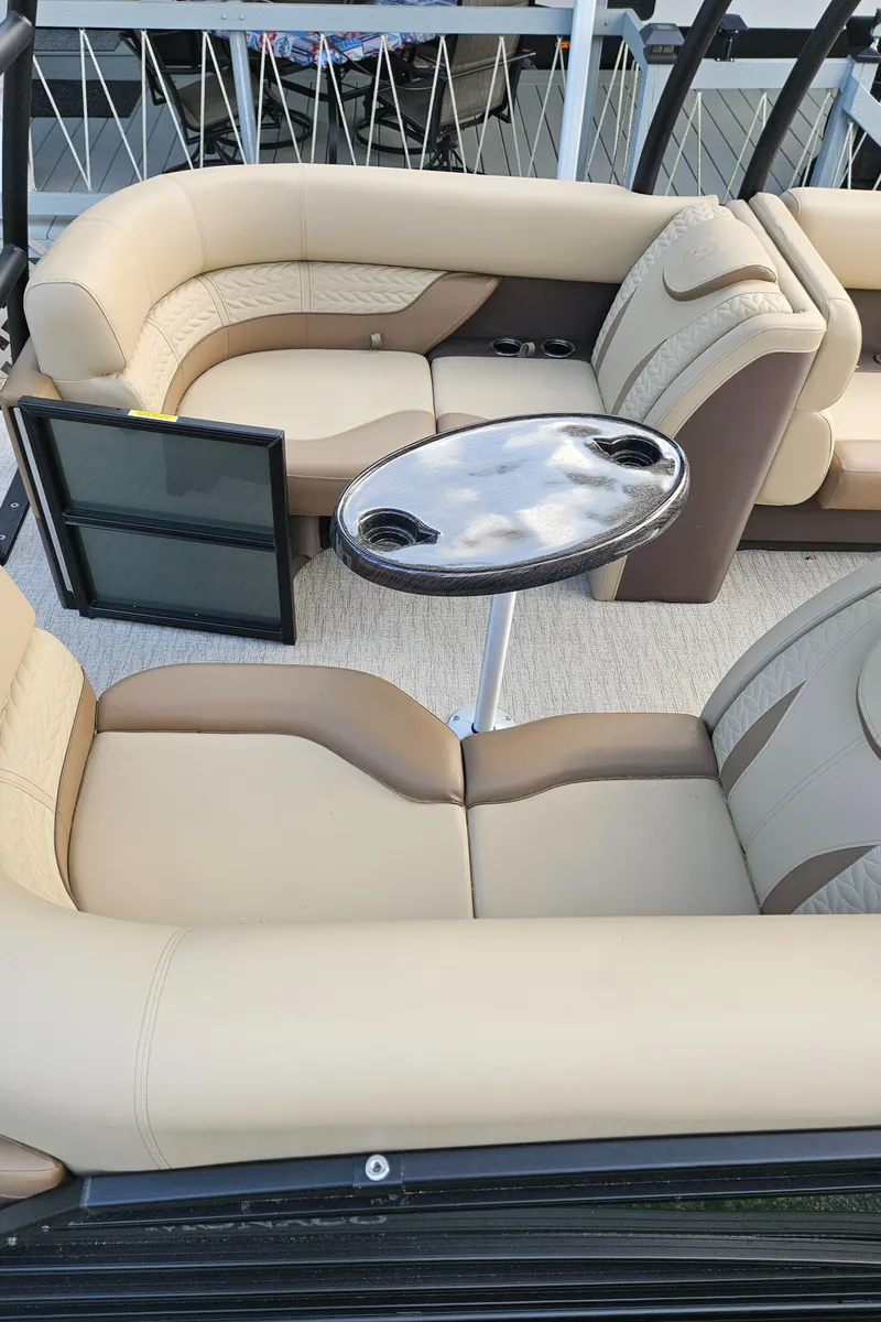 Slide: The Image of Luxurious seating on 2025 Godfrey MC255 SD boat with table and cup holders. - 11