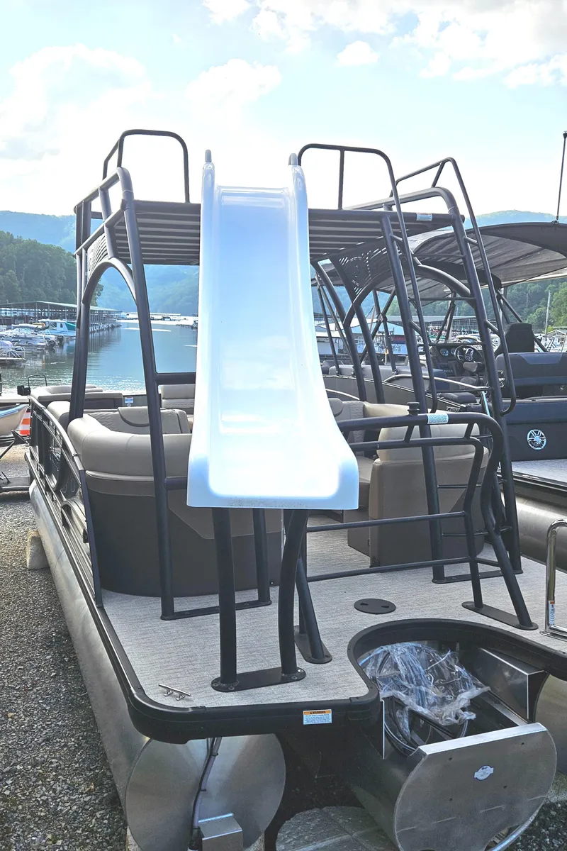 Slide: The Image of 2025 Godfrey MC255 SD pontoon boat with slide, docked at marina. - 2