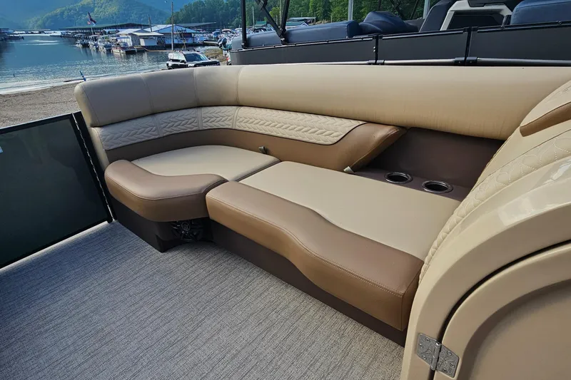 Slide: The Image of Luxurious seating on 2025 Godfrey MC255 SD boat, featuring beige and brown upholstery with cup holders. - 7