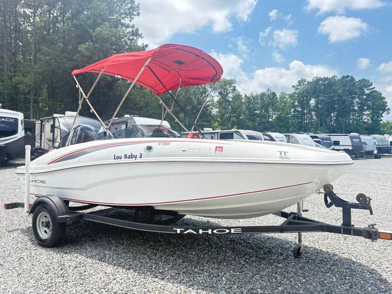 The Image of 2021 Tahoe T16 boat with red canopy on trailer, parked outdoors. - 0