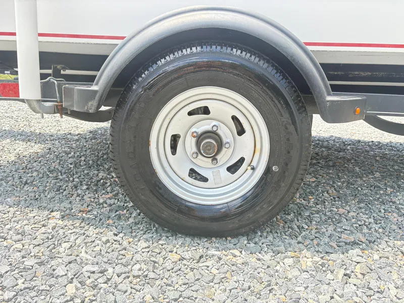 Slide: The Image of Trailer wheel of a 2021 Tahoe T16 on gravel surface. - 12