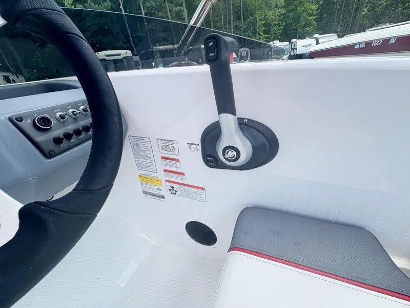 Slide: The Image of 2021 Tahoe T16 boat with red canopy, parked near RVs and trailers. - 5