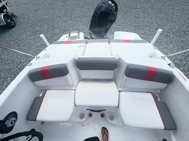 Slide: The Image of Dashboard of a 2021 Tahoe T16 boat with gauges and controls, parked near RVs. - 6