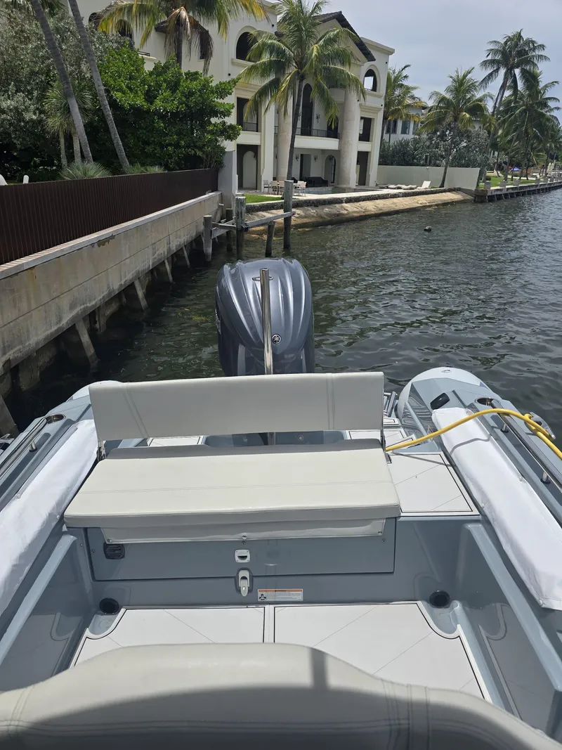 Slide: The Image of 2025 Ranieri CAYMAN 26 SPORT TOURING boat docked by waterfront mansion. - 12