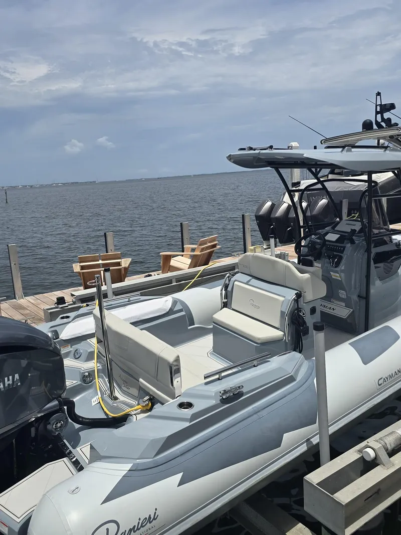 Slide: The Image of 2025 Ranieri CAYMAN 26 SPORT TOURING boat docked by the water on a sunny day. - 19
