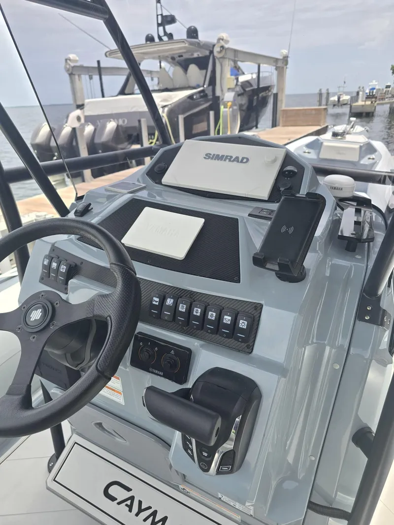 Slide: The Image of Cockpit of 2025 Ranieri CAYMAN 26 SPORT TOURING with steering wheel and control panel. - 22