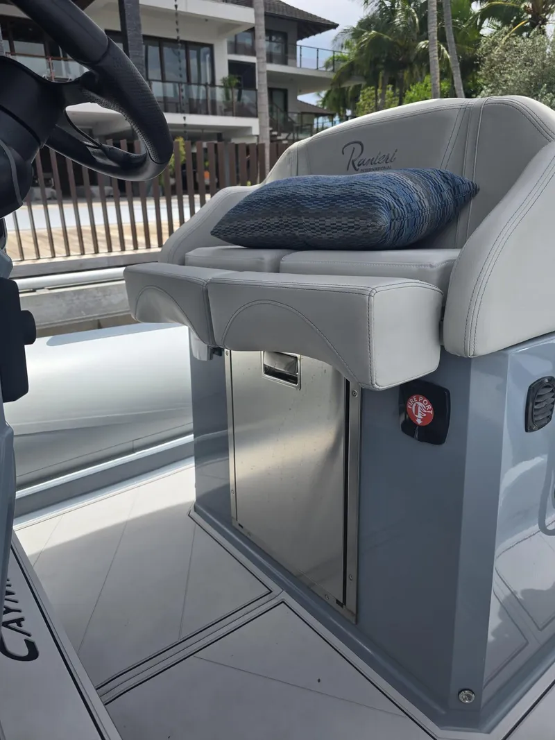 Slide: The Image of 2025 Ranieri CAYMAN 26 SPORT TOURING boat interior with cushioned seating and sleek design. - 24