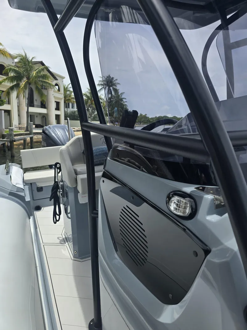 Slide: The Image of 2025 Ranieri CAYMAN 26 SPORT TOURING boat interior with steering console and seating. - 28