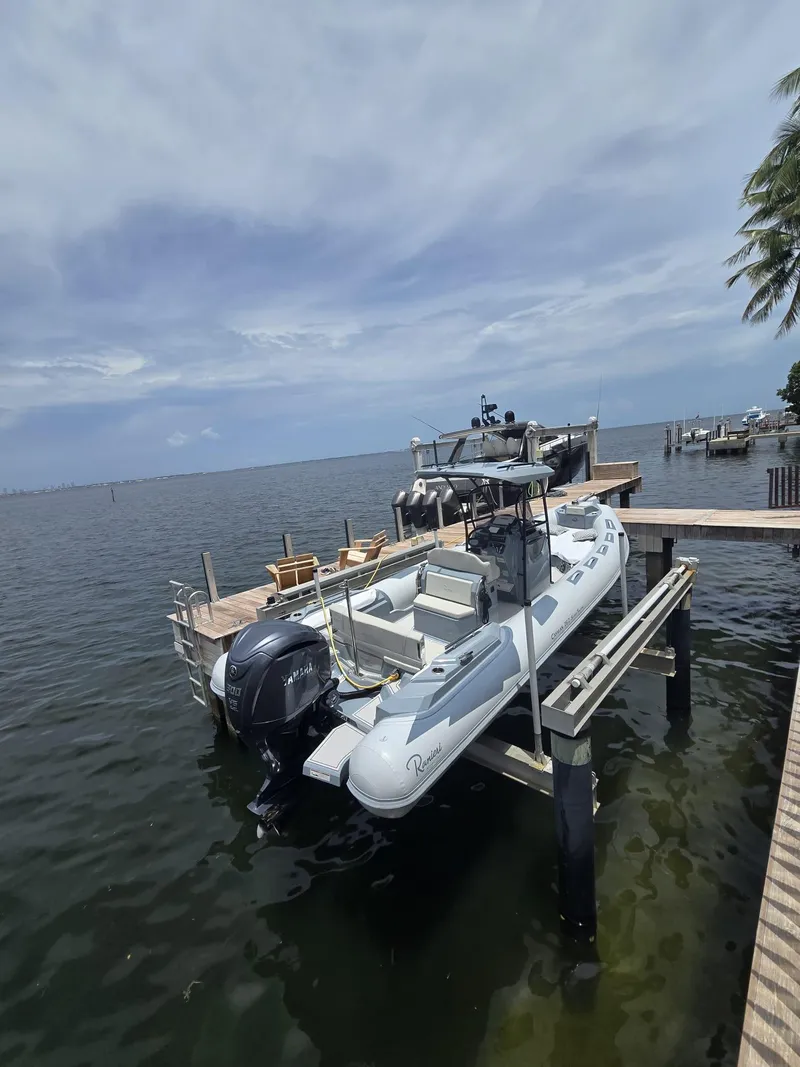 Slide: The Image of 2025 Ranieri CAYMAN 26 SPORT TOURING boat docked by the waterfront. - 3