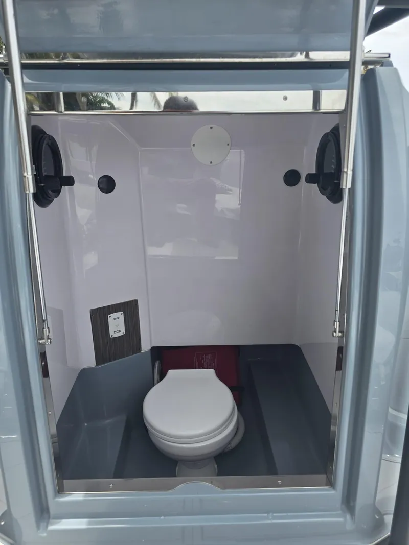 Slide: The Image of Interior of 2025 Ranieri CAYMAN 26 SPORT TOURING boat with compact marine toilet. - 33