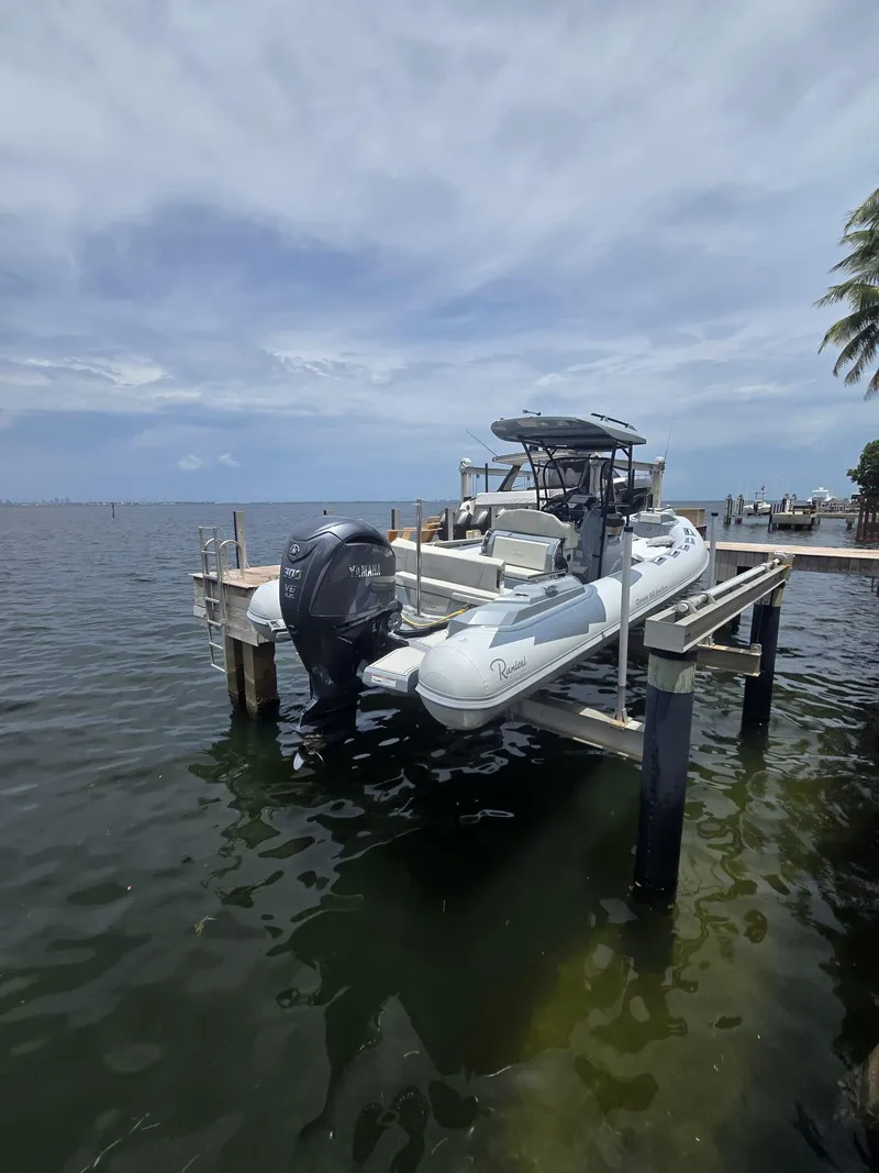 Slide: The Image of 2025 Ranieri CAYMAN 26 SPORT TOURING boat docked by the water. - 5