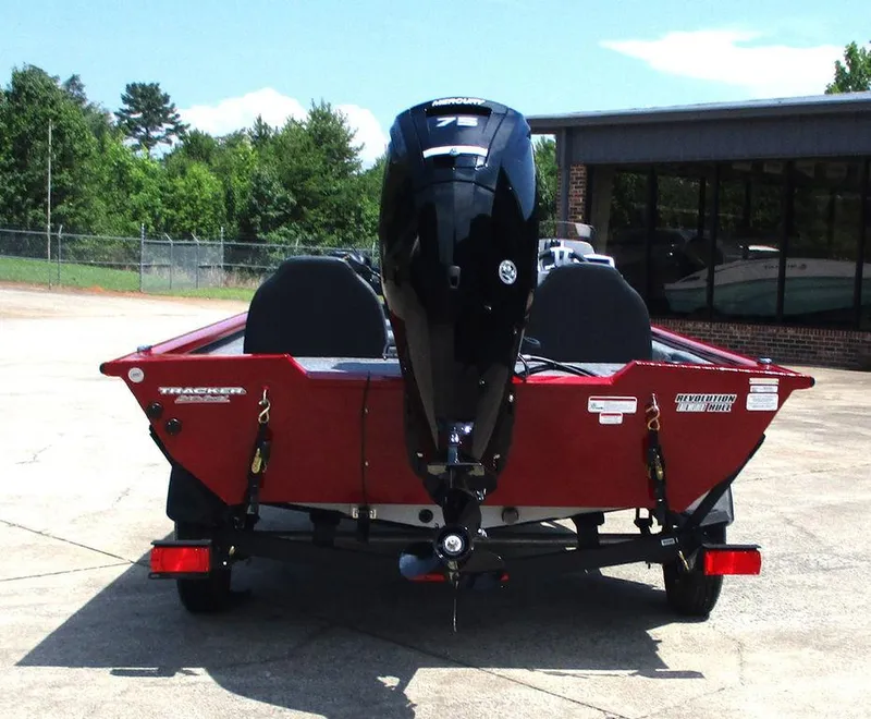 Slide: The Image of 2026 Tracker Pro Team™ 175 boat with powerful outboard motor, parked outdoors. - 4
