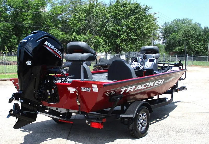 Slide: The Image of 2026 Tracker Pro Team™ 175 boat with Mercury engine, parked outdoors on a sunny day. - 5