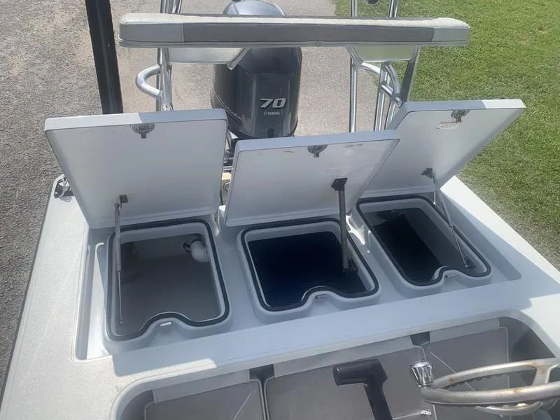 Slide: The Image of Open storage compartments on a 2018 Custom Biscayne boat with Yamaha 70 engine. - 12