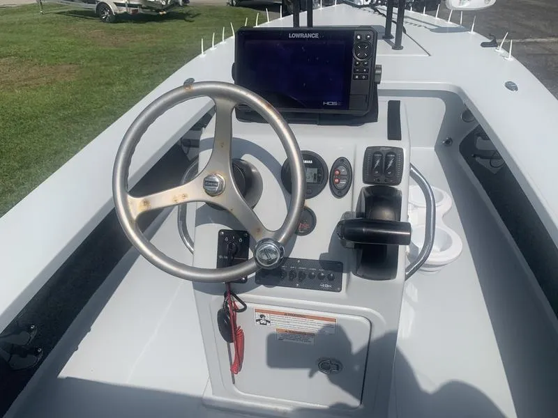 Slide: The Image of 2018 Custom Biscayne boat dashboard with steering wheel, Lowrance GPS, and control panel. - 13