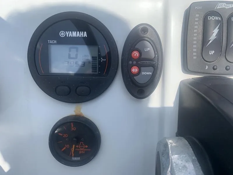 Slide: The Image of Control panel of a 2018 Custom Biscayne boat with Yamaha tachometer and switches. - 15