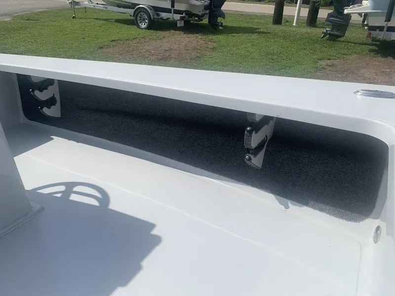 Slide: The Image of 2018 Custom Biscayne boat interior with rod holders and carpeted storage area. - 17