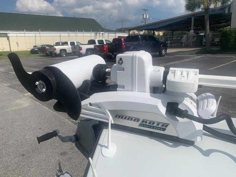Slide: The Image of Minn Kota trolling motor mounted on a 2018 Custom Biscayne boat in a parking lot. - 21