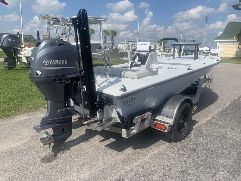 Slide: The Image of 2018 Custom Biscayne boat with Yamaha motor on trailer, parked outdoors under blue sky. - 4