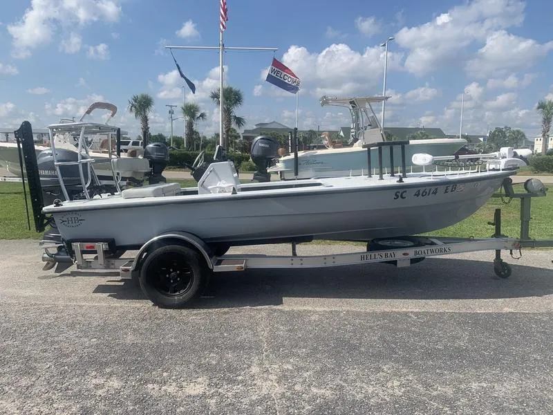 Slide: The Image of Custom Biscayne 2018 boat on trailer, parked outdoors under a clear sky. - 5