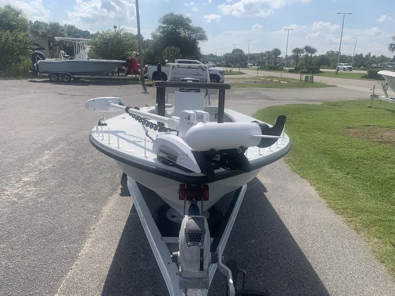 Slide: The Image of Custom Biscayne 2018 boat on trailer, parked outdoors under a sunny sky. - 7